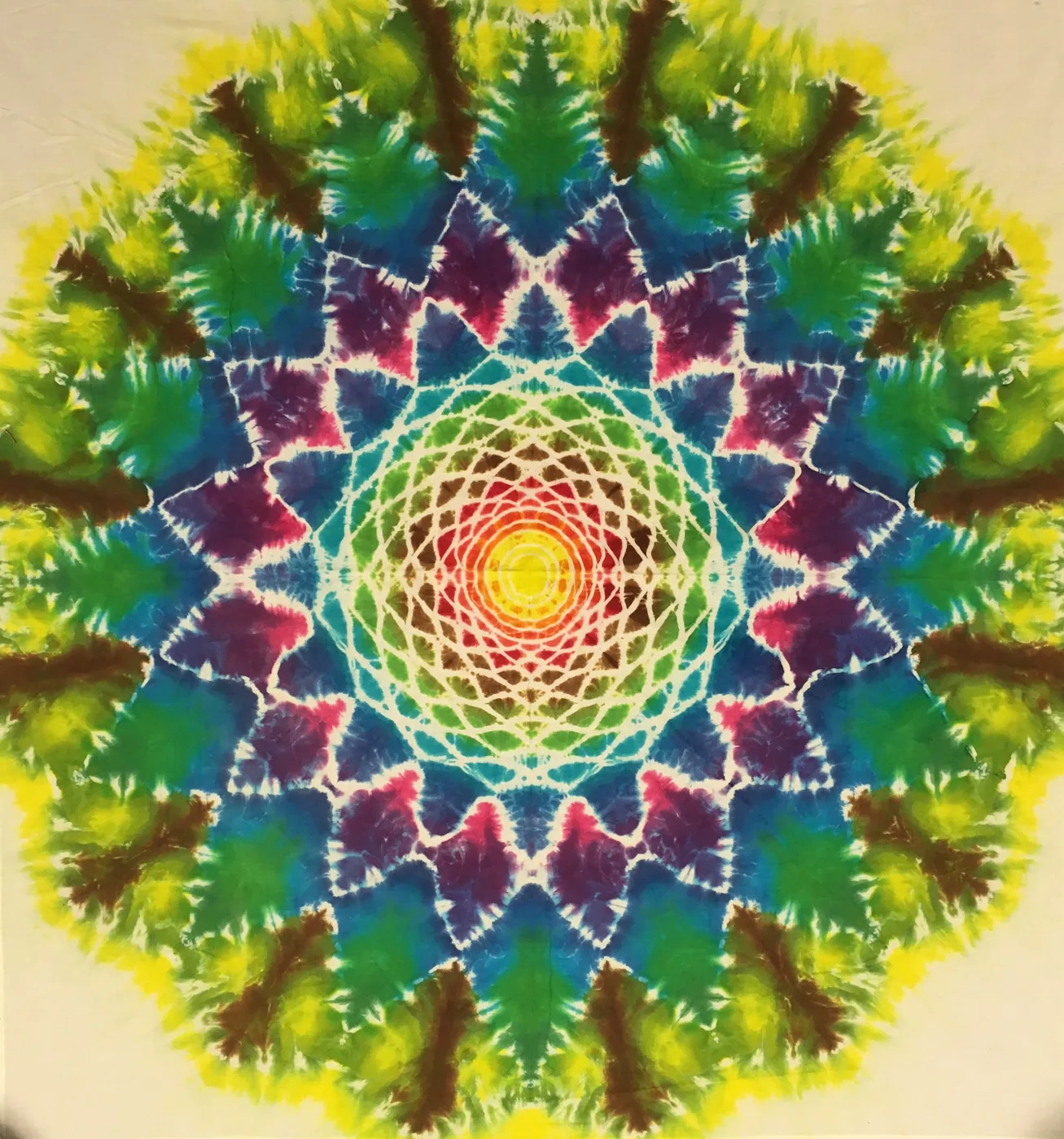 Tie-dye mandala in greens, blues, purples and a yellow center