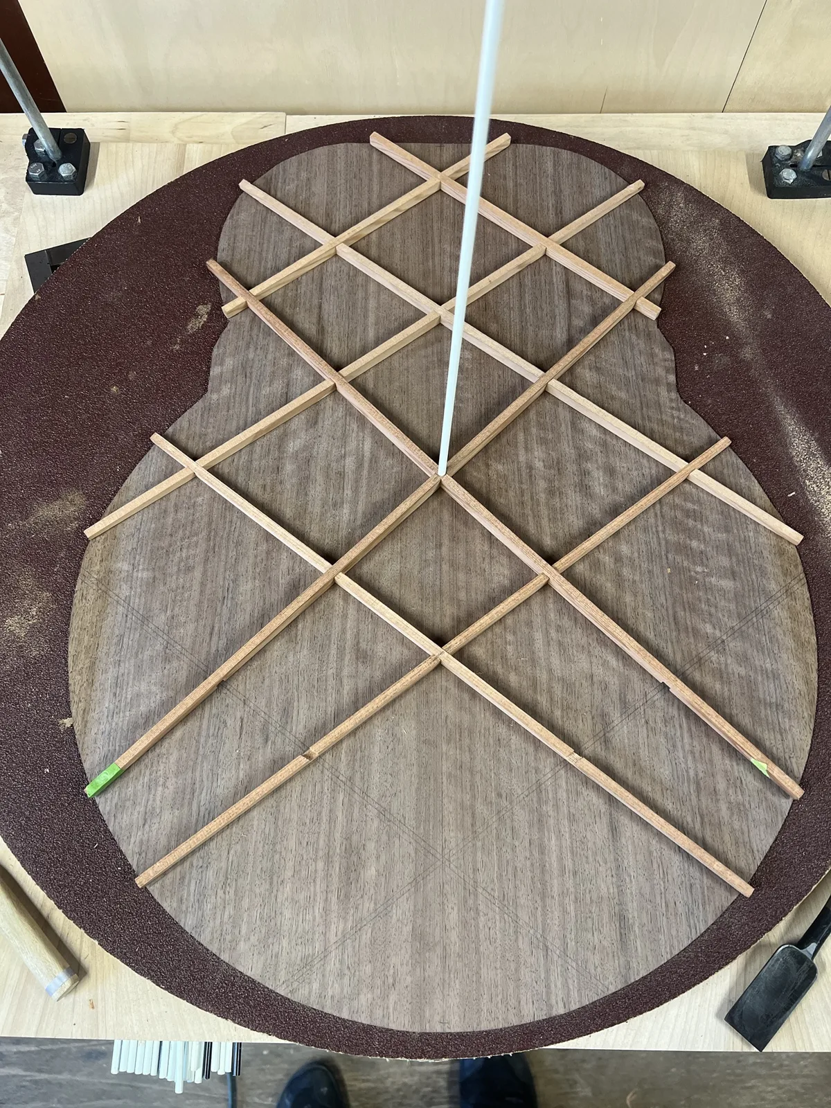 Lattice bracing being glued to a walnut plate in the go-bar deck, held down with flexible rods